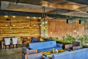 A contemporary café in Ahmedabad showcasing modern furniture and industrial elements.